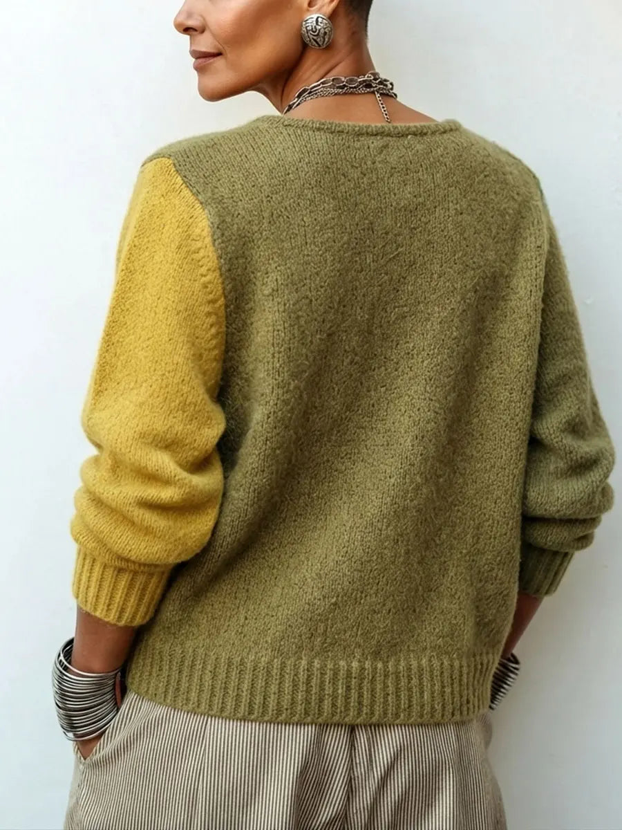Back view of the sweater, showing a plain olive back with one mustard sleeve and ribbed hem 3