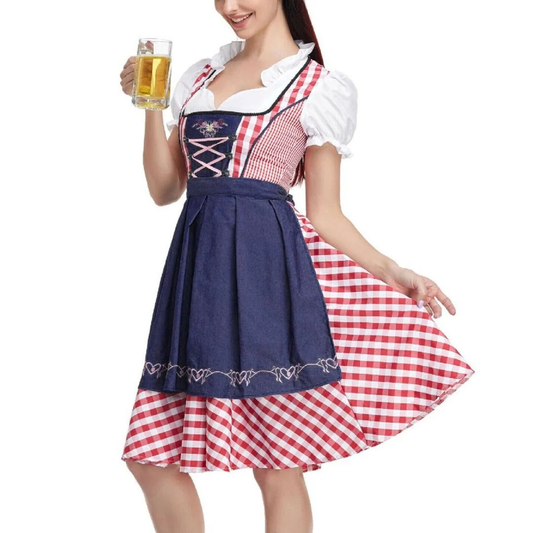Model holding a glass of beer, wearing the red check dirndl with a navy denim-look apron and pink lacing. 2