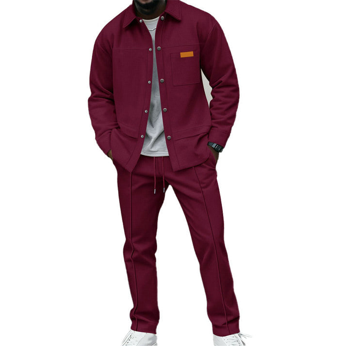 Model wearing the set in burgundy, shirt over a grey tee with white trainers 6