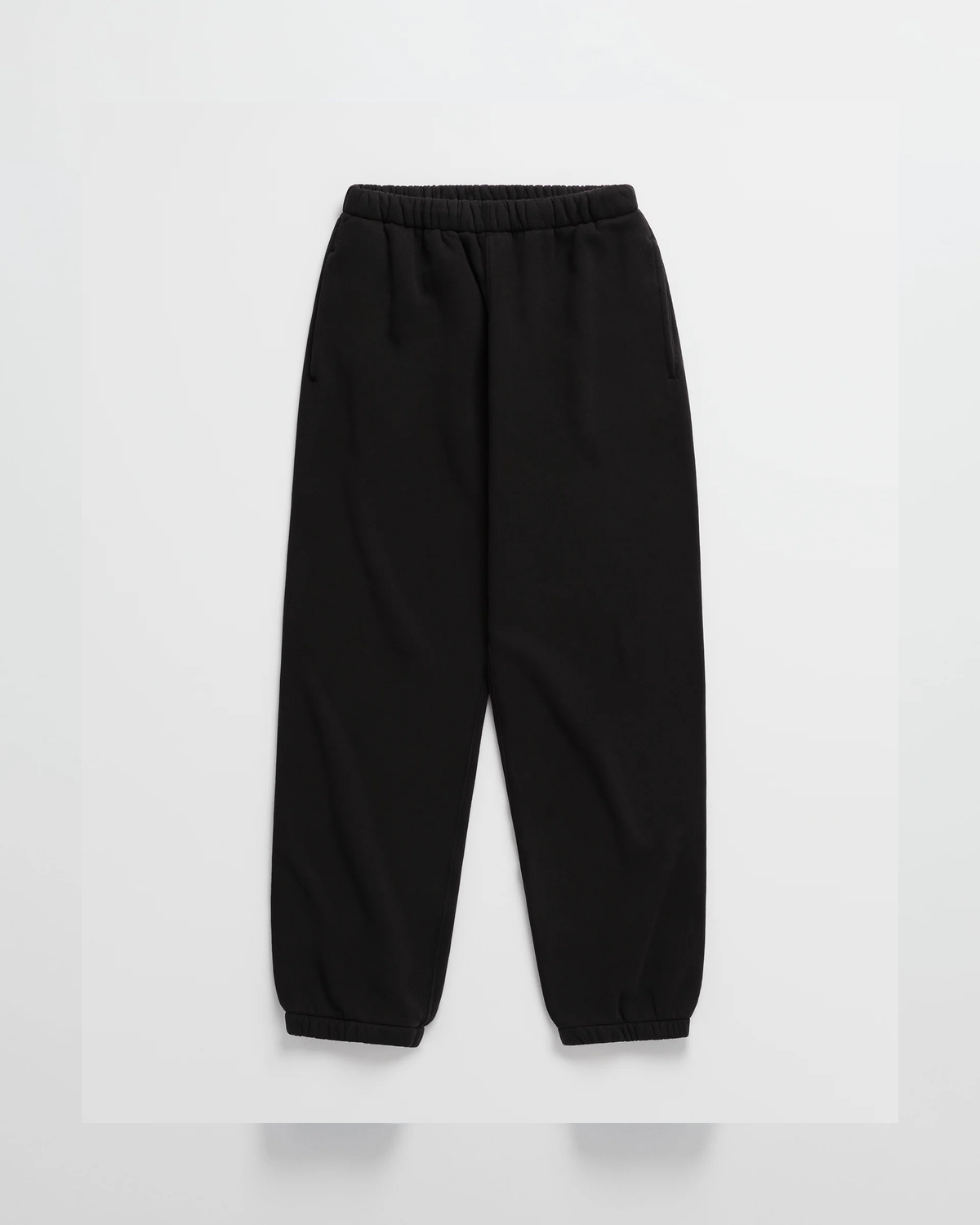 Flat lay of matching black joggers with an elastic waistband, side pockets and cuffed hems 10