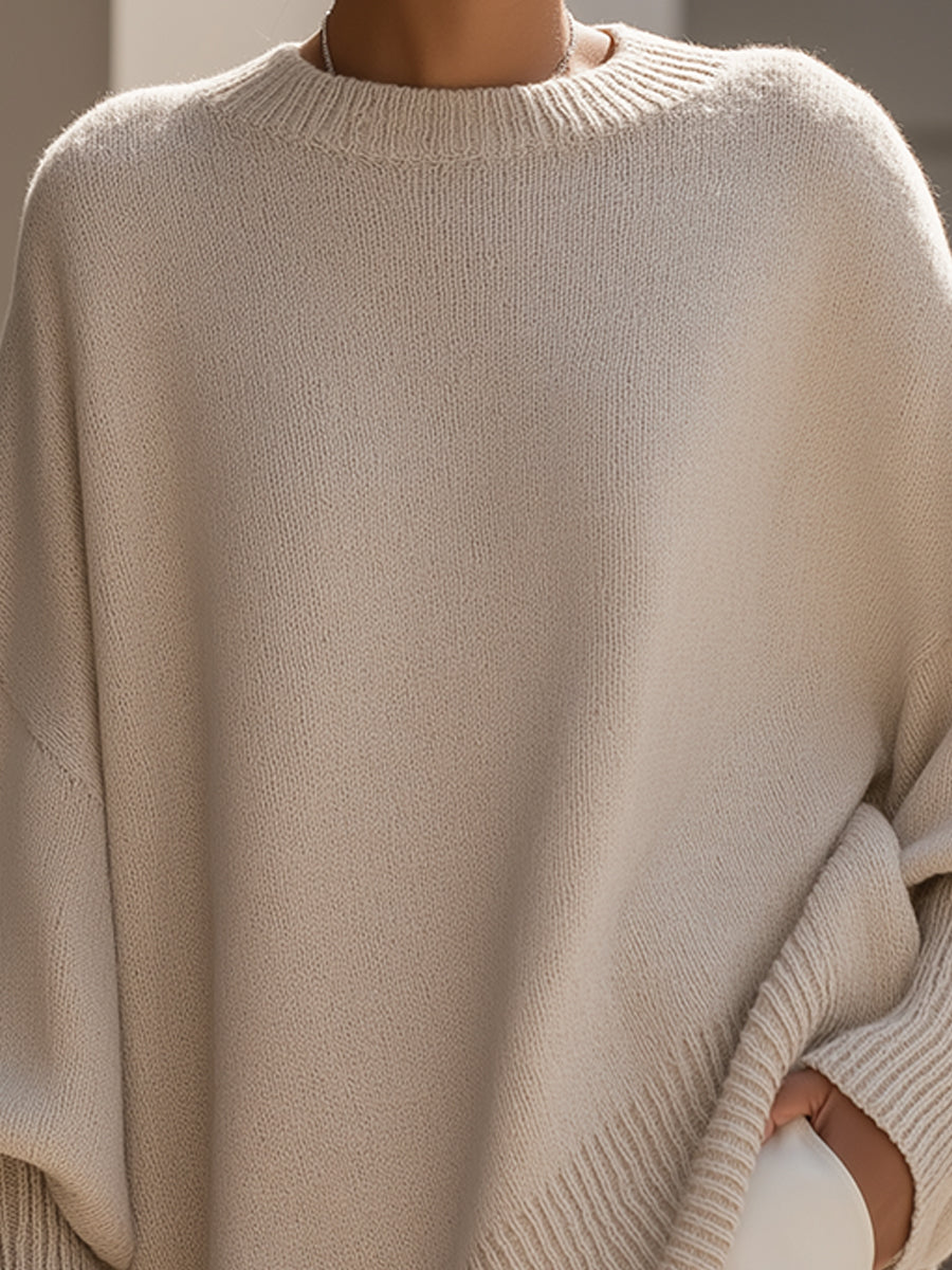 Close-up of the beige knit's ribbed round neckline and fine, soft stitch texture 3