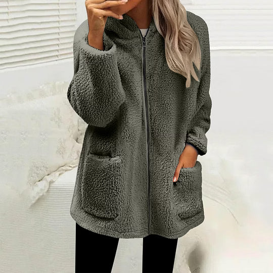 Model wearing the zipped fluffy fleece jacket in dark olive green with black leggings, hand in a pocket 8