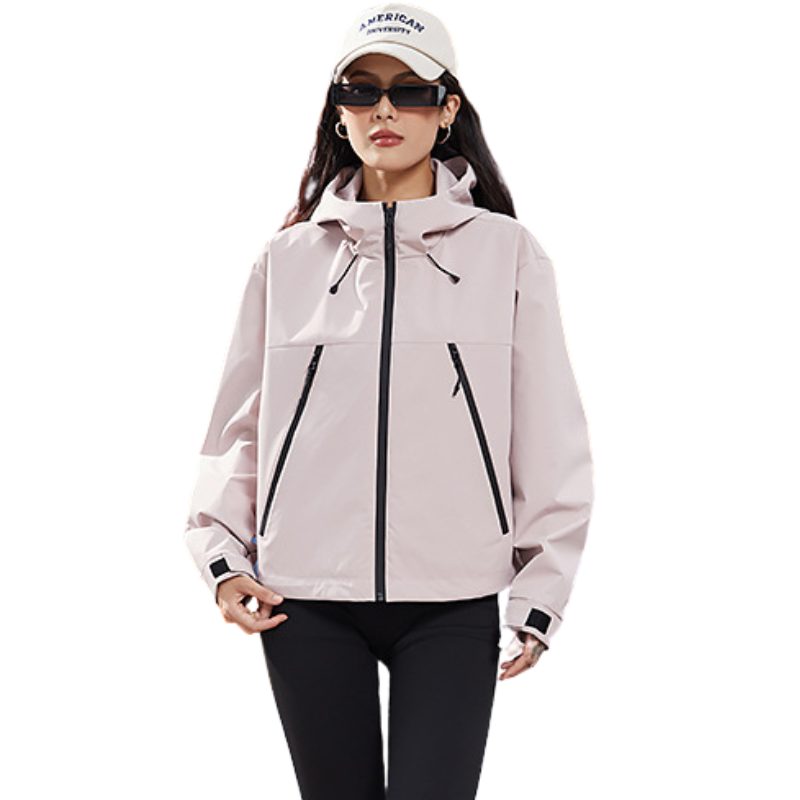 Front view of the jacket in pale pink, worn open-handed with black leggings and a white cap 9
