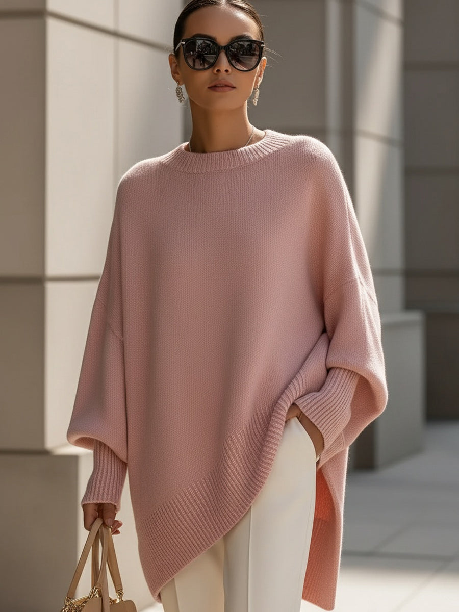 Soft pink version of the knit poncho worn with cream trousers and sunglasses 11