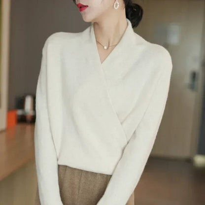 Cream wrap jumper worn by a model in profile, with brown herringbone trousers 12