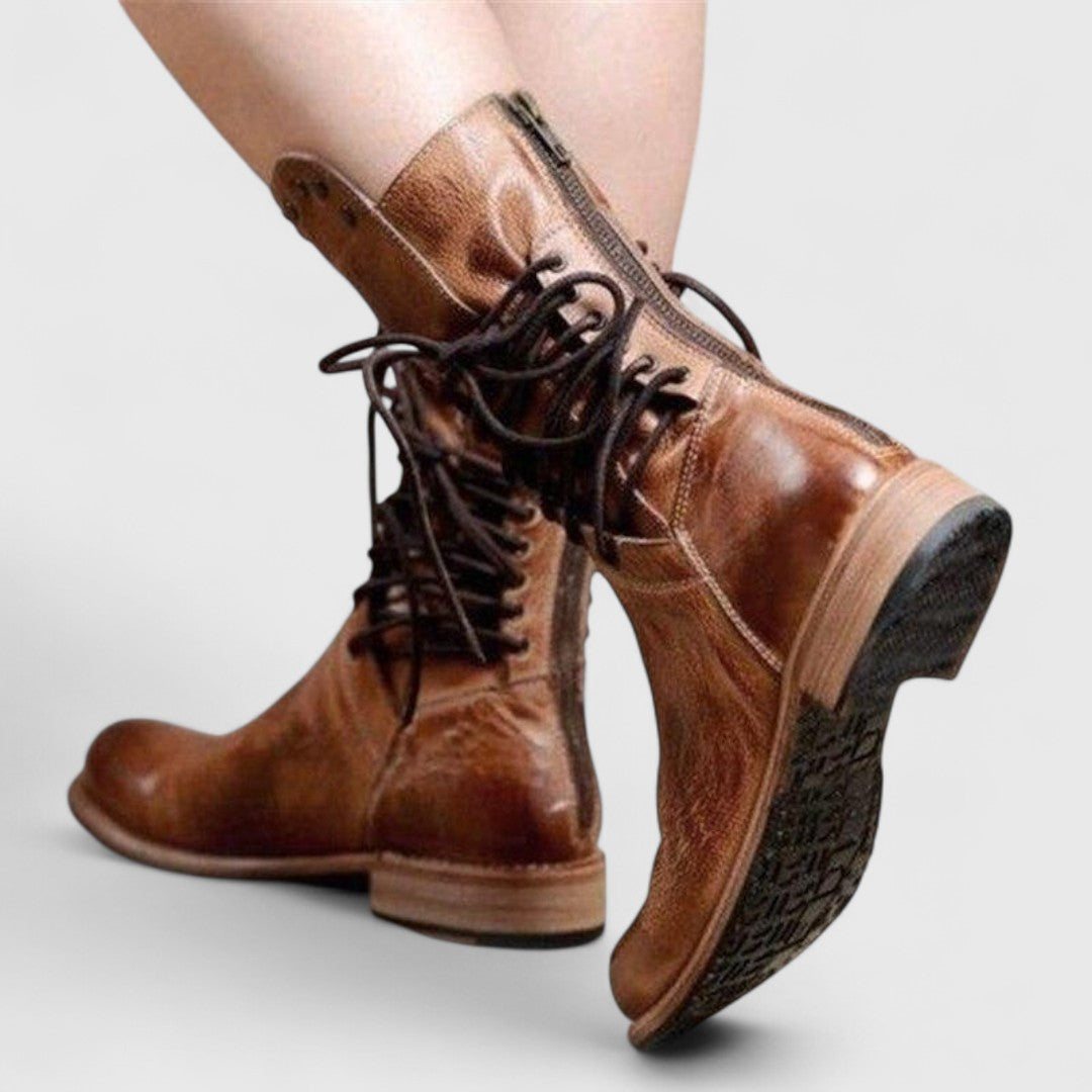 Back and side view of brown leather boots with a rear zip, dark laces and a visible tread on the sole. 10
