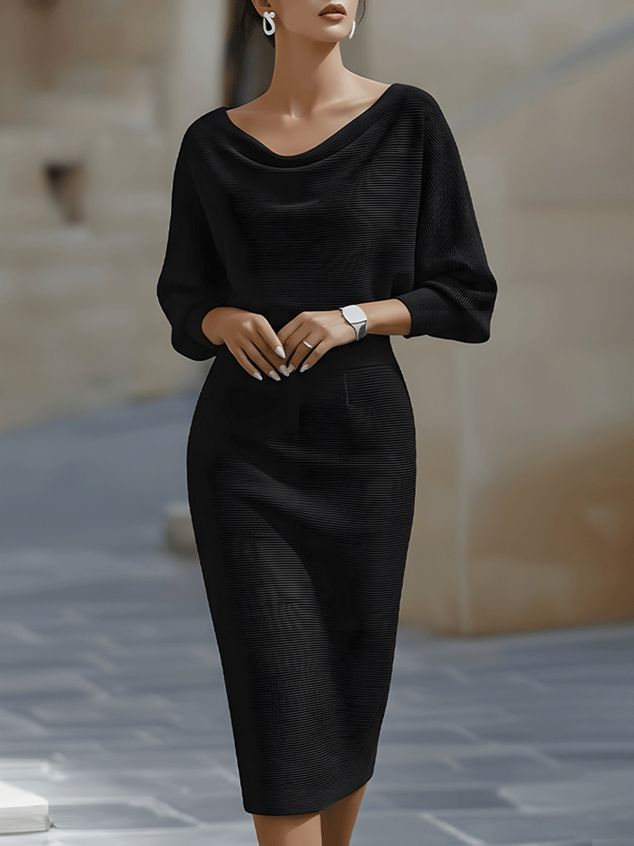 Model wearing the black ribbed-knit midi dress with draped neckline and batwing sleeves, front view outdoors 1