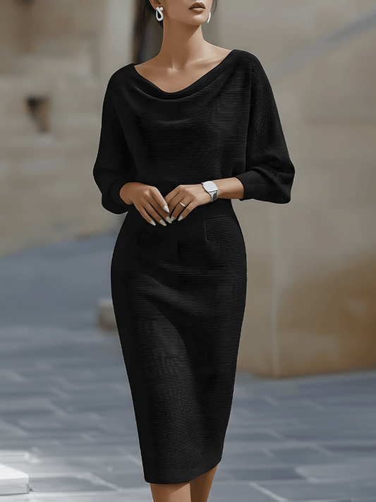 Model wearing the black ribbed-knit midi dress with draped neckline and batwing sleeves, front view outdoors 1