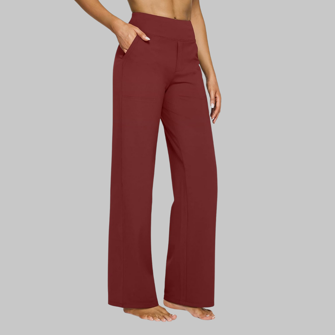 Side view of the high-waist straight-leg trousers in deep burgundy red, worn by a barefoot model with a hand in the pocket. 11