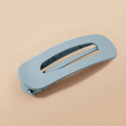 Matte pale blue-grey clip at an angle, showing the oval opening, inner teeth and hinge 10