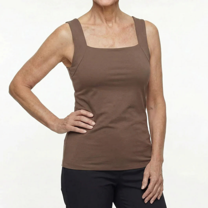 Front view of a woman wearing a fitted brown sleeveless top with a square neckline and wide straps, with black trousers. 3