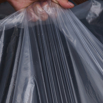 Hand gathering a fold of the thin, clear, creased plastic sheeting, showing the texture and flexibility of the material. 6