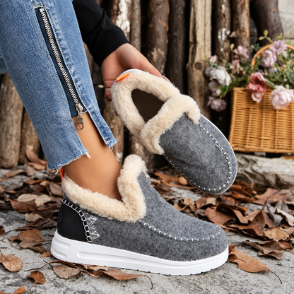 Grey slip-ons with fluffy lining, one worn and one held up to show the plush interior 5