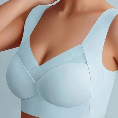Model wearing the seamless bra in pale blue, showing the wide straps and mesh V-neck trim 18