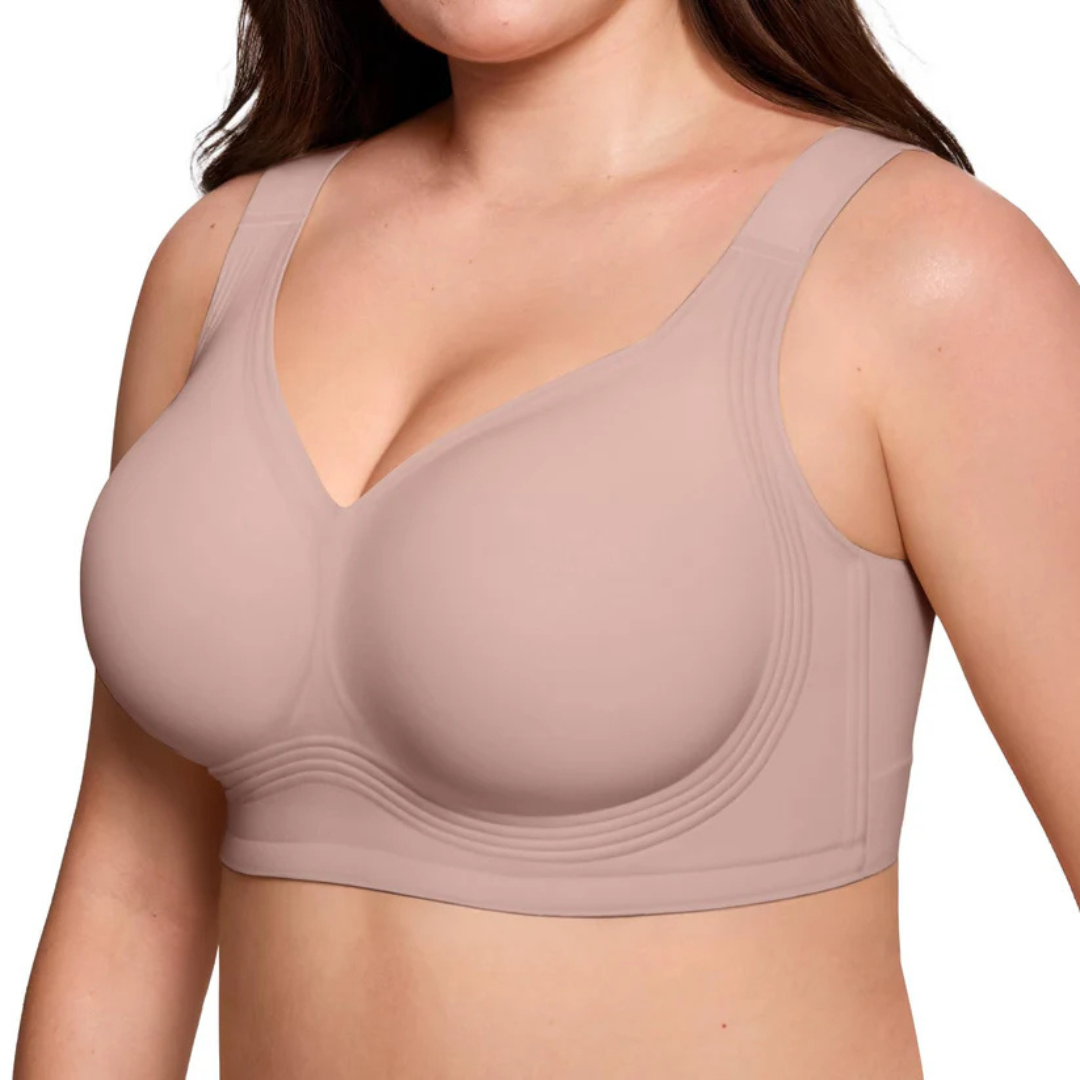 Three-quarter view of the dusky pink wireless bra on a model, showing the V-neckline and wavy lower band 8