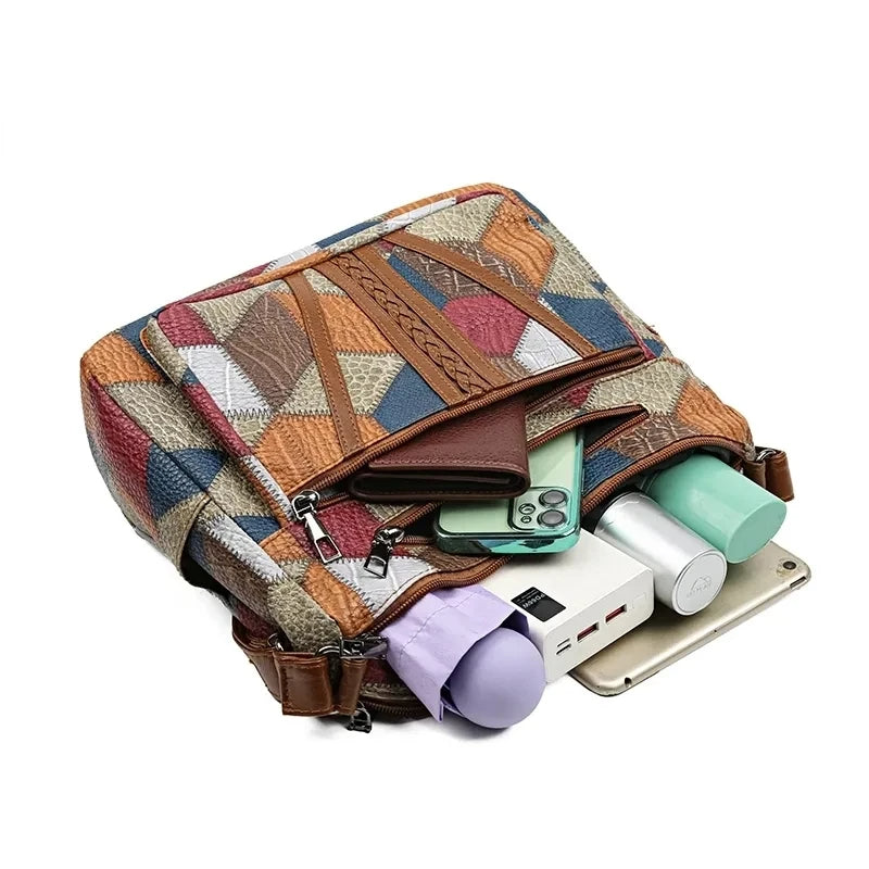 Bag lying flat with a wallet, phone, power bank, bottle, umbrella and tablet tucked into its compartments. 14