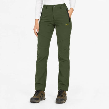 Front view of the trousers in dark olive green, worn with hiking boots 7
