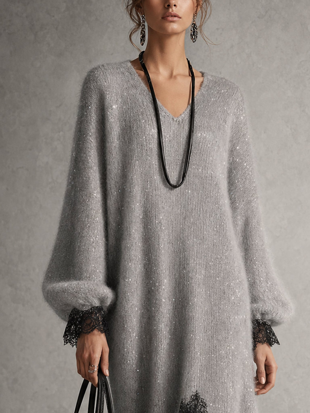 Close-up of the grey sparkly knit bodice, V-neckline, puff sleeves and black lace cuffs 6