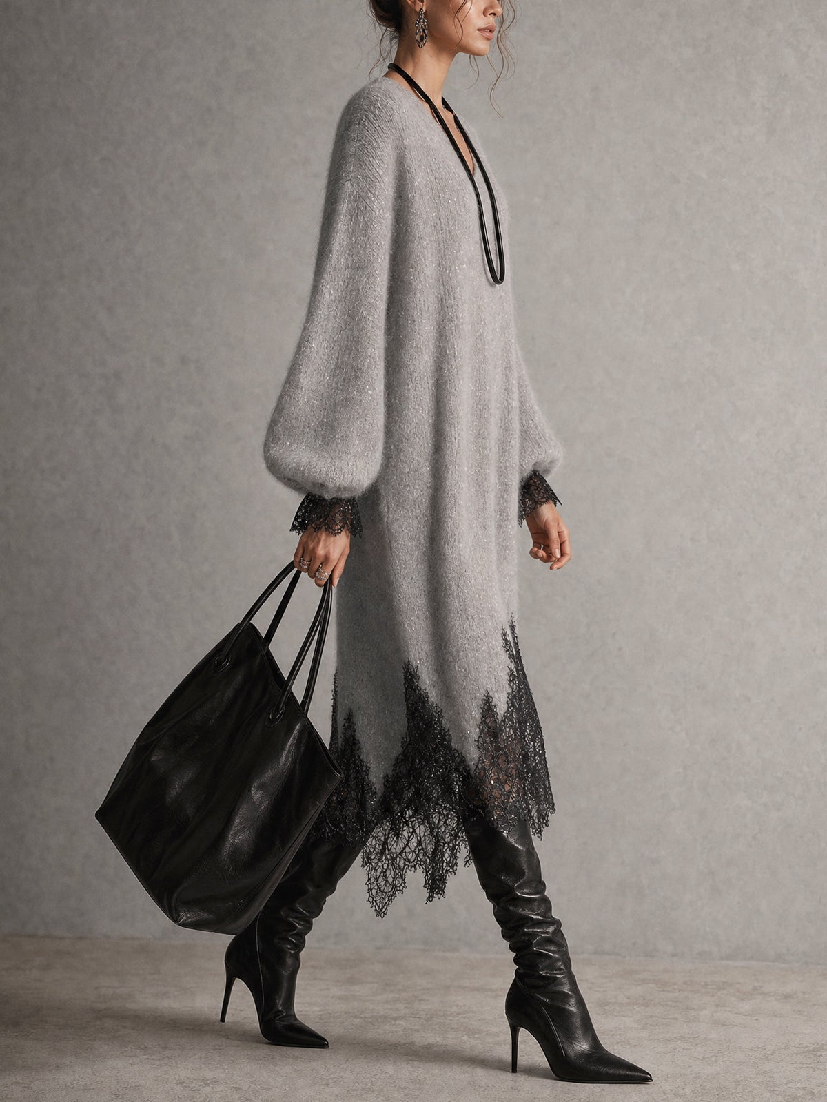 Side view of the grey dress on a walking model, showing the puff sleeve and jagged lace hem 5
