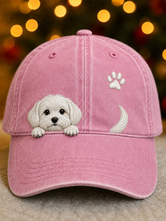 Front view of the pink washed cap showing a peeking white puppy, paw print and tail 2