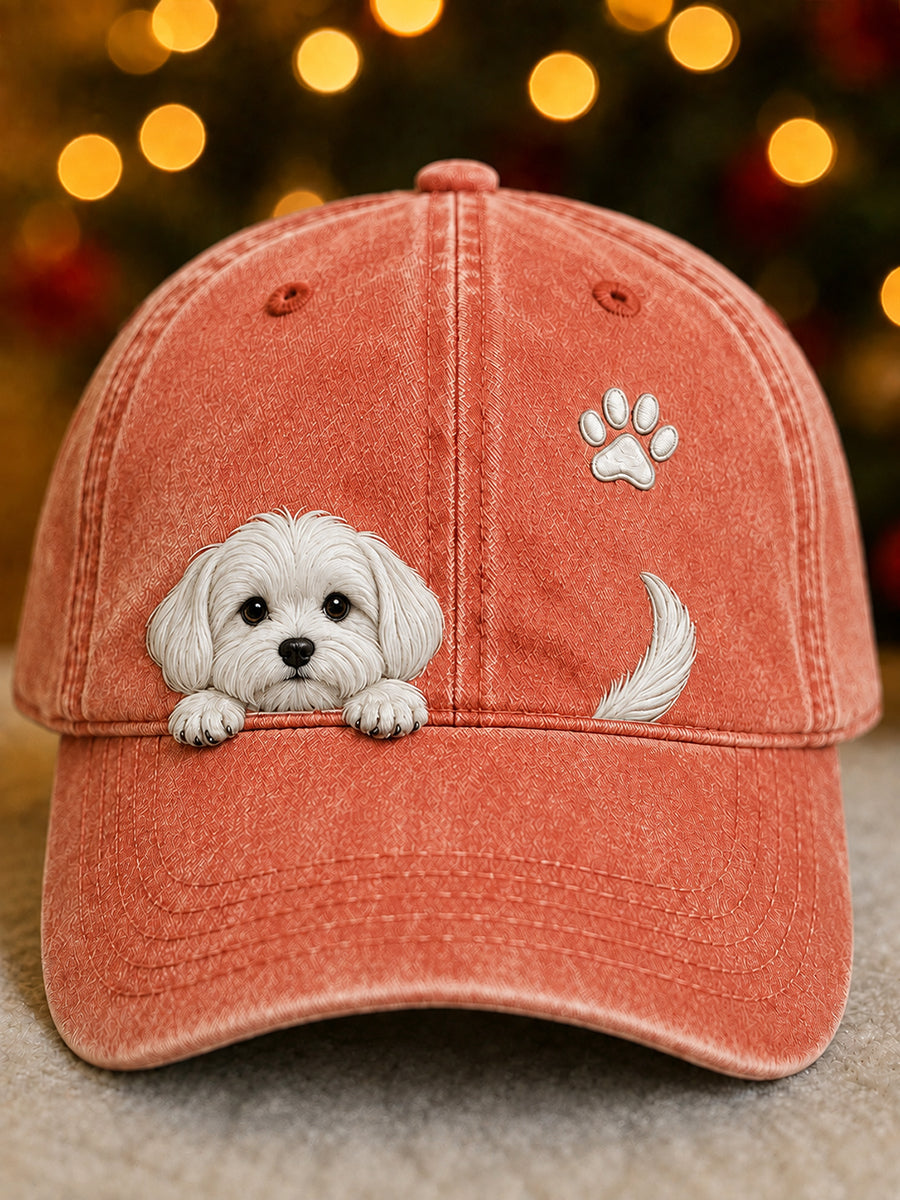 Front view of the coral-orange washed cap with a peeking white puppy, paw print and tail 5