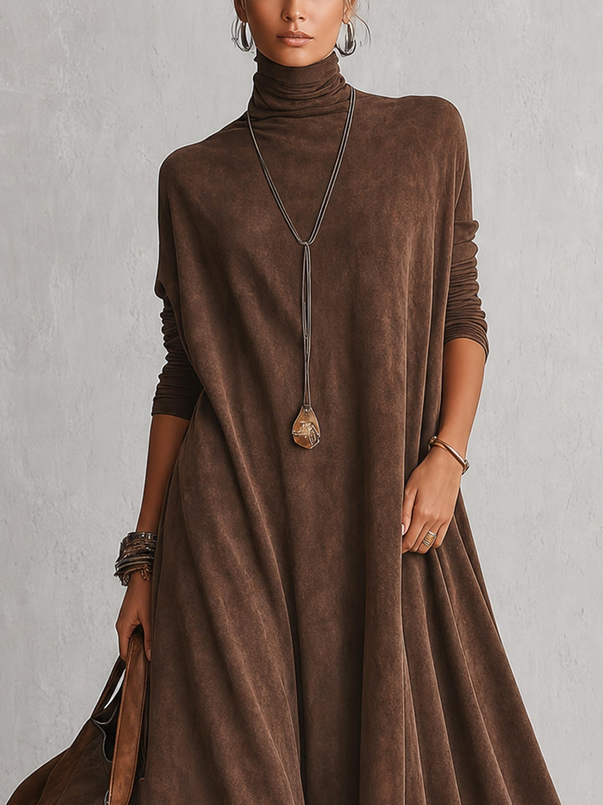 Close-up of the brown dress's turtleneck, batwing sleeves and pendant necklace on the upper body 7