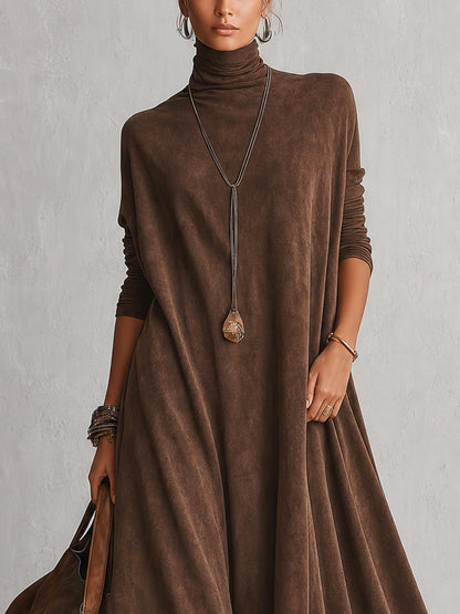 Close-up of the brown dress's turtleneck, batwing sleeves and pendant necklace on the upper body 7
