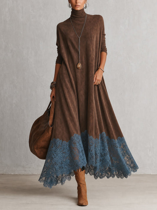 Model in brown roll-neck maxi dress with blue lace hem, carrying a tan leather bag 1
