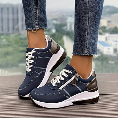 Navy lace-up trainers with side zip and chunky white sole, worn with cropped jeans outdoors 1