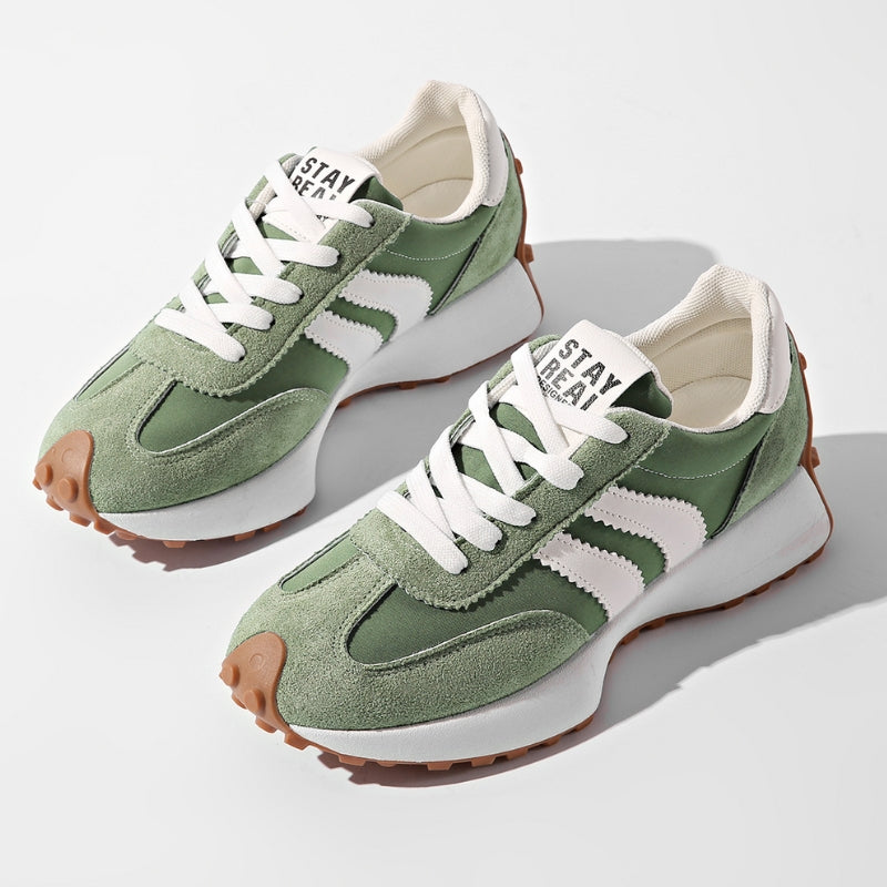 Pair of sage green suede and nylon trainers with white side stripes and gum soles, seen from above 1