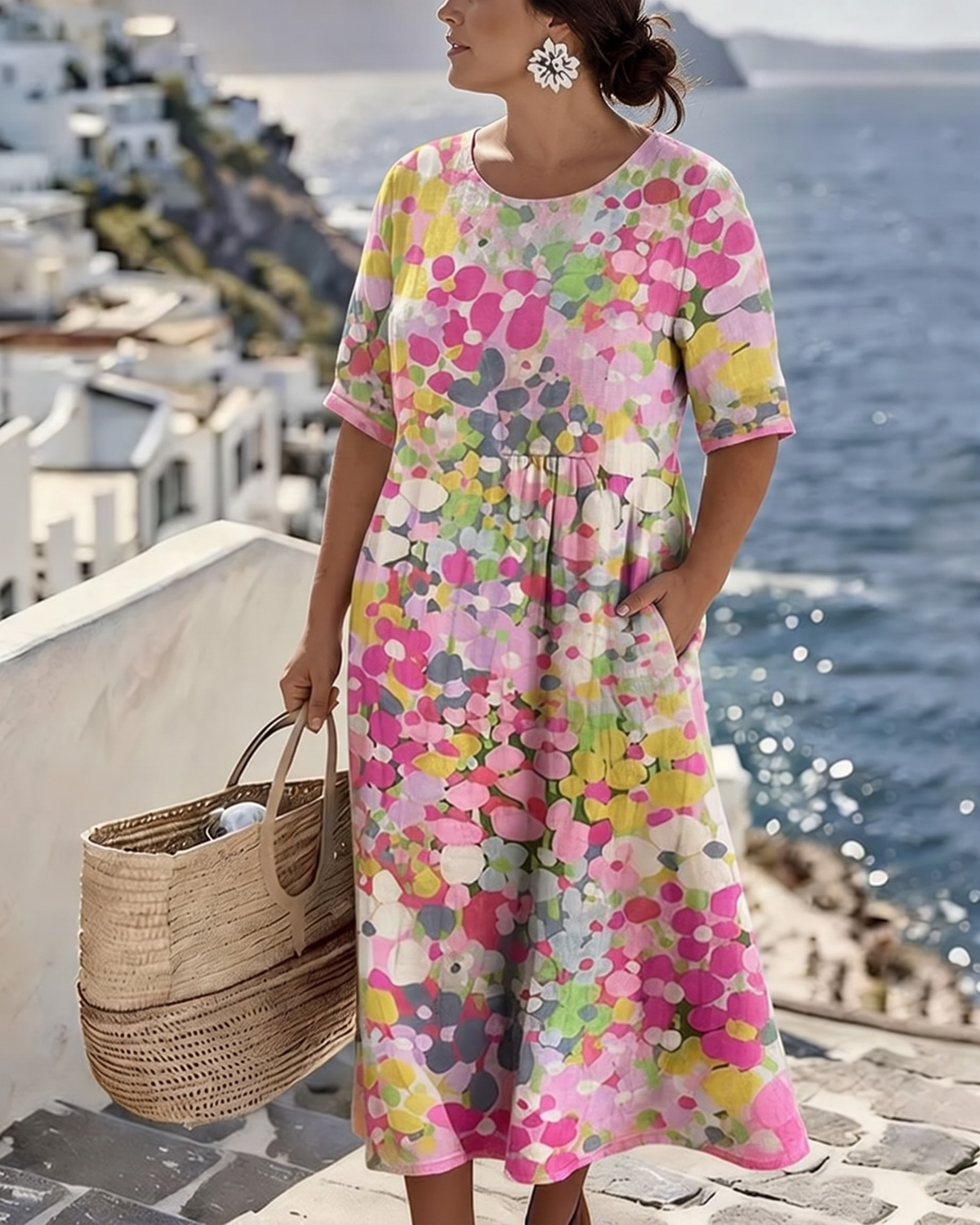 Fuller-length view of the pink floral dress worn by a second model, one hand in a side pocket 2