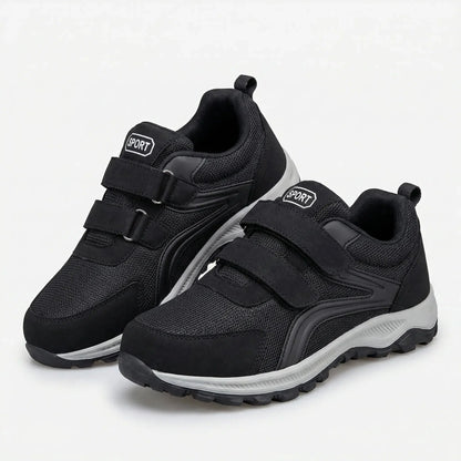 Pair of black shoes with grey soles and double straps, shown at an angle on white 5