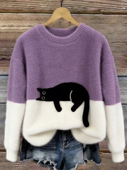 Lilac and white fluffy jumper with black cat motif, hanging on a wooden background 11