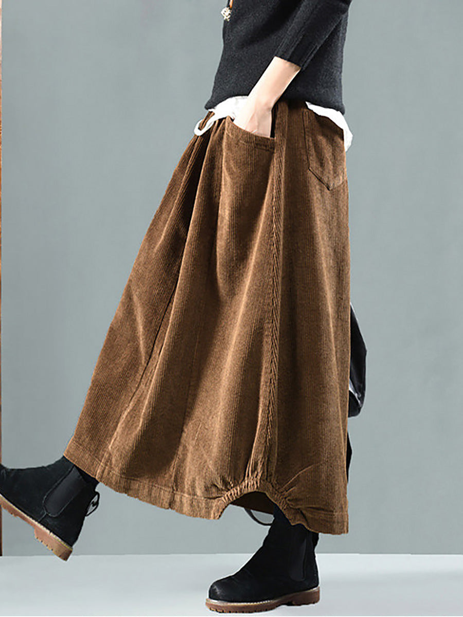 Brown corduroy version worn by a model, hand in pocket, with a gathered hem detail 3