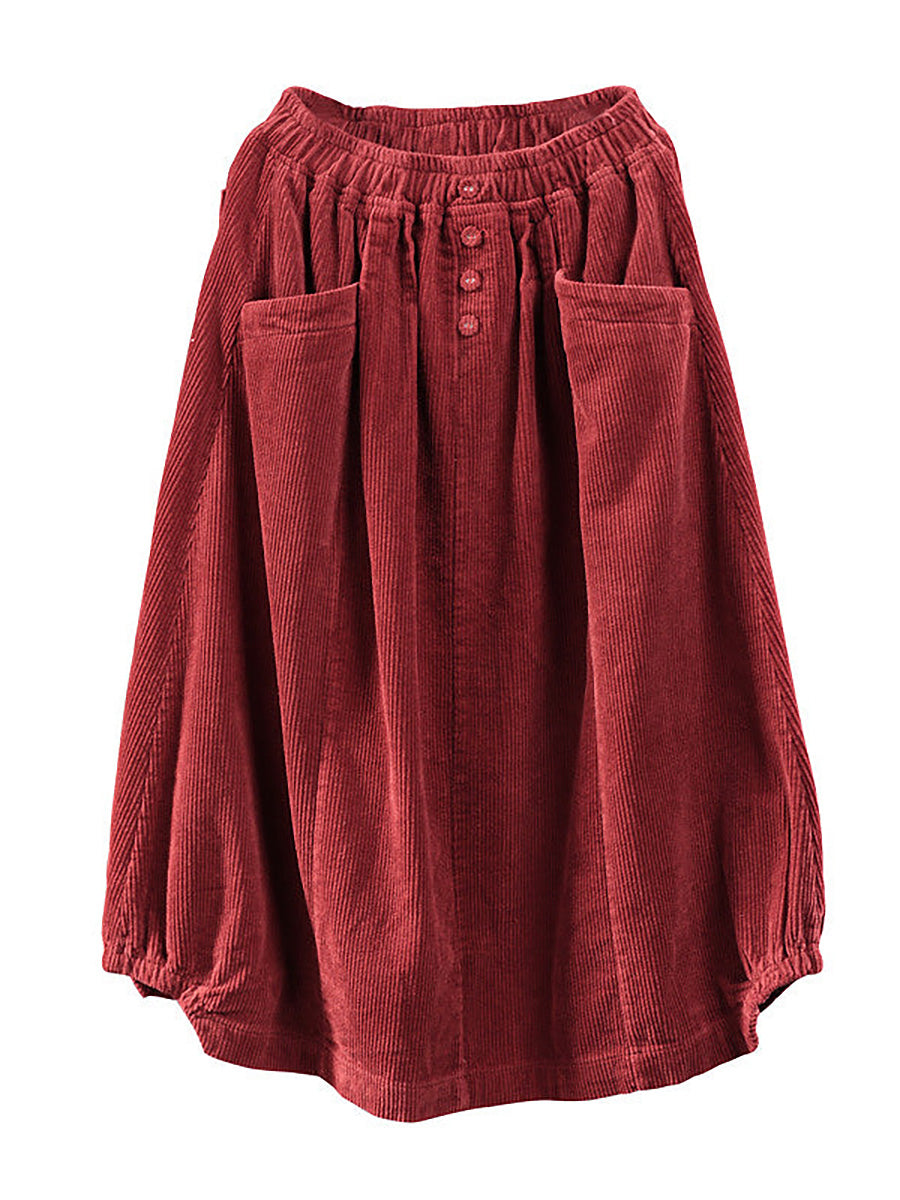 Red corduroy skirt laid flat, showing the elastic waistband, three buttons, two patch pockets and gathered hem 6