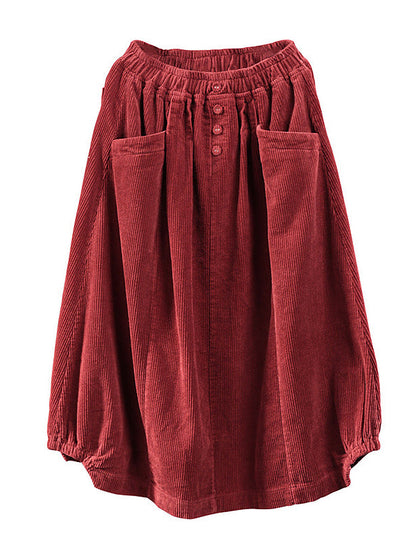 Red corduroy skirt laid flat, showing the elastic waistband, three buttons, two patch pockets and gathered hem 6