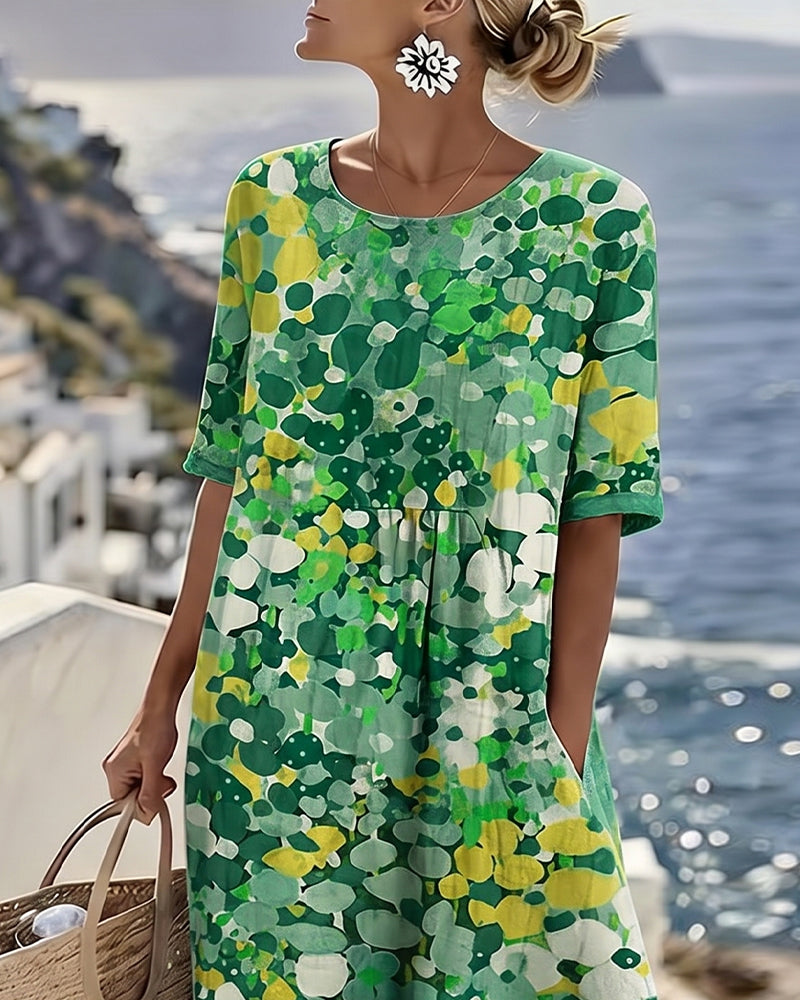 Close-up of the green floral dress's round neckline and short cuffed sleeves on a model 8