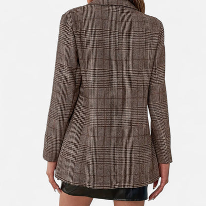Close back view of the brown checked blazer on a model, showing the plain back panel, long sleeves and houndstooth-style check pattern. 4