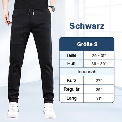 Black trousers on a model next to a small-size measurement chart in German 4