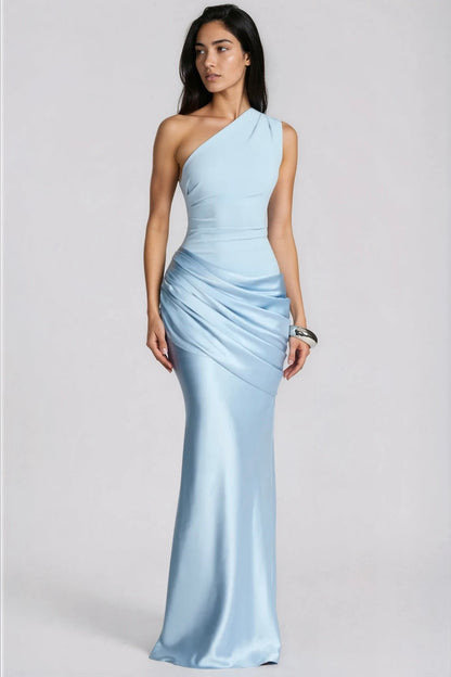 Model in pale blue one-shoulder gown with draped satin waist, angled front view, wearing a chunky silver cuff 1