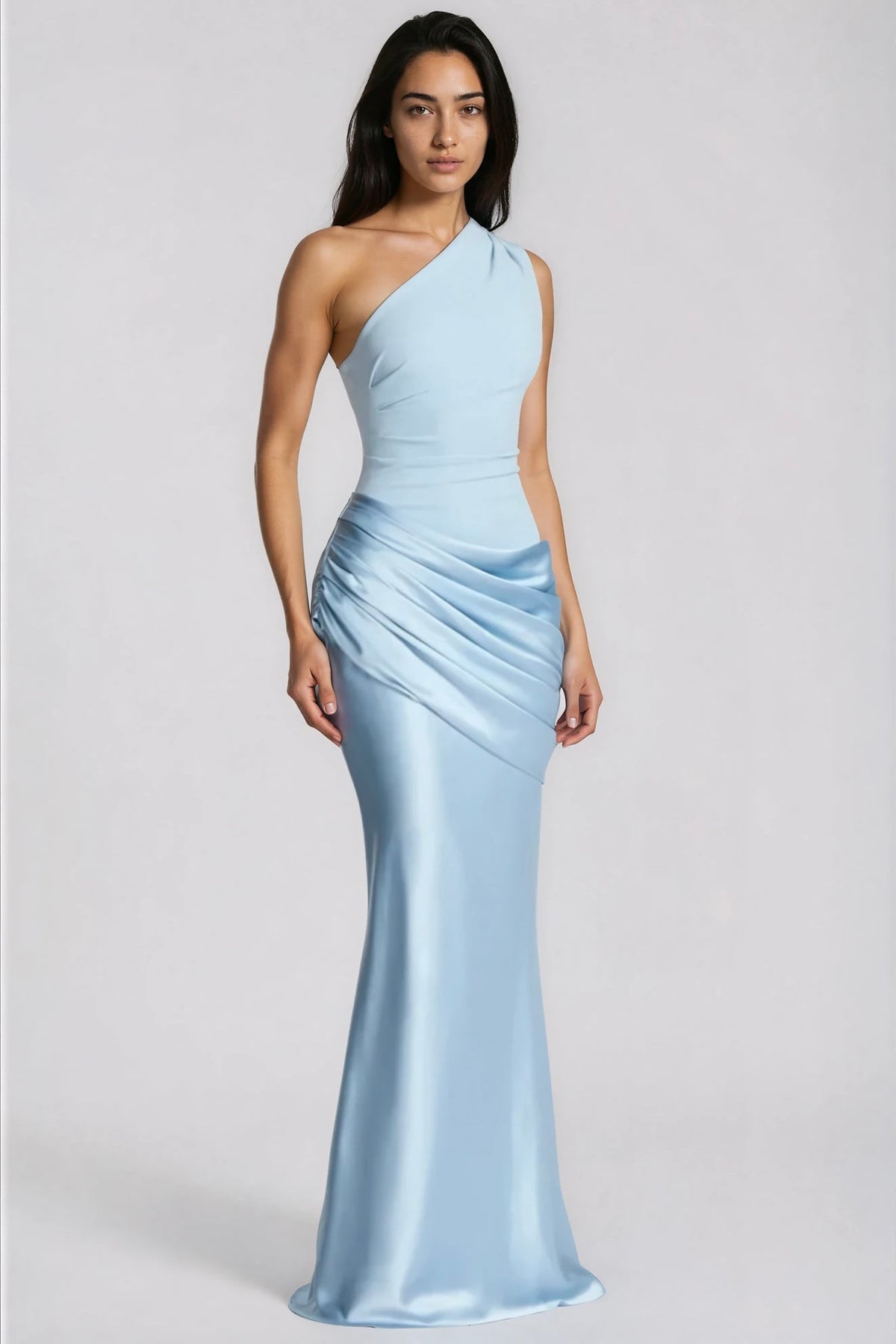 Full-length front view of the pale blue one-shoulder gown on a model, arms relaxed at her sides 3