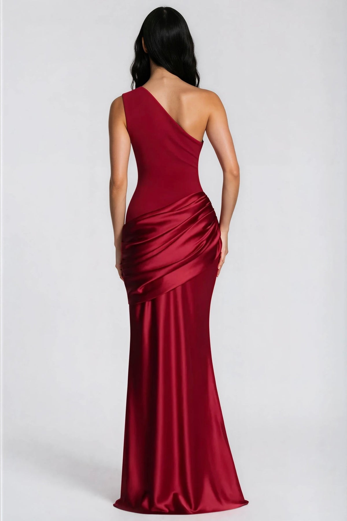 Back view of the deep red dress, showing the one-shoulder cut and draped satin hip panel 35