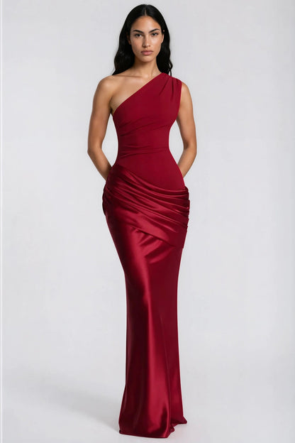 Front view of the red dress with hands behind the back, showing the draped waist and full-length skirt 37