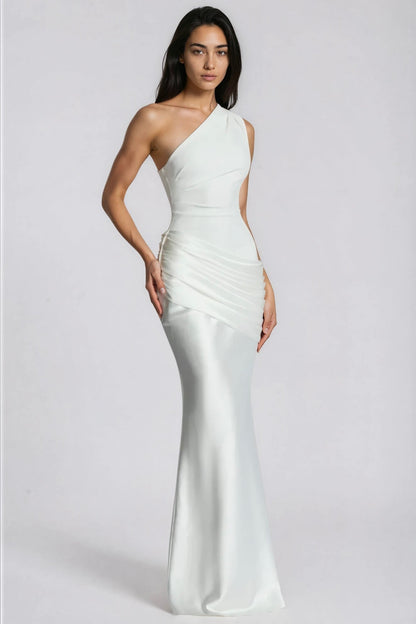 White one-shoulder gown at a three-quarter angle, with one hand resting at the hip 11