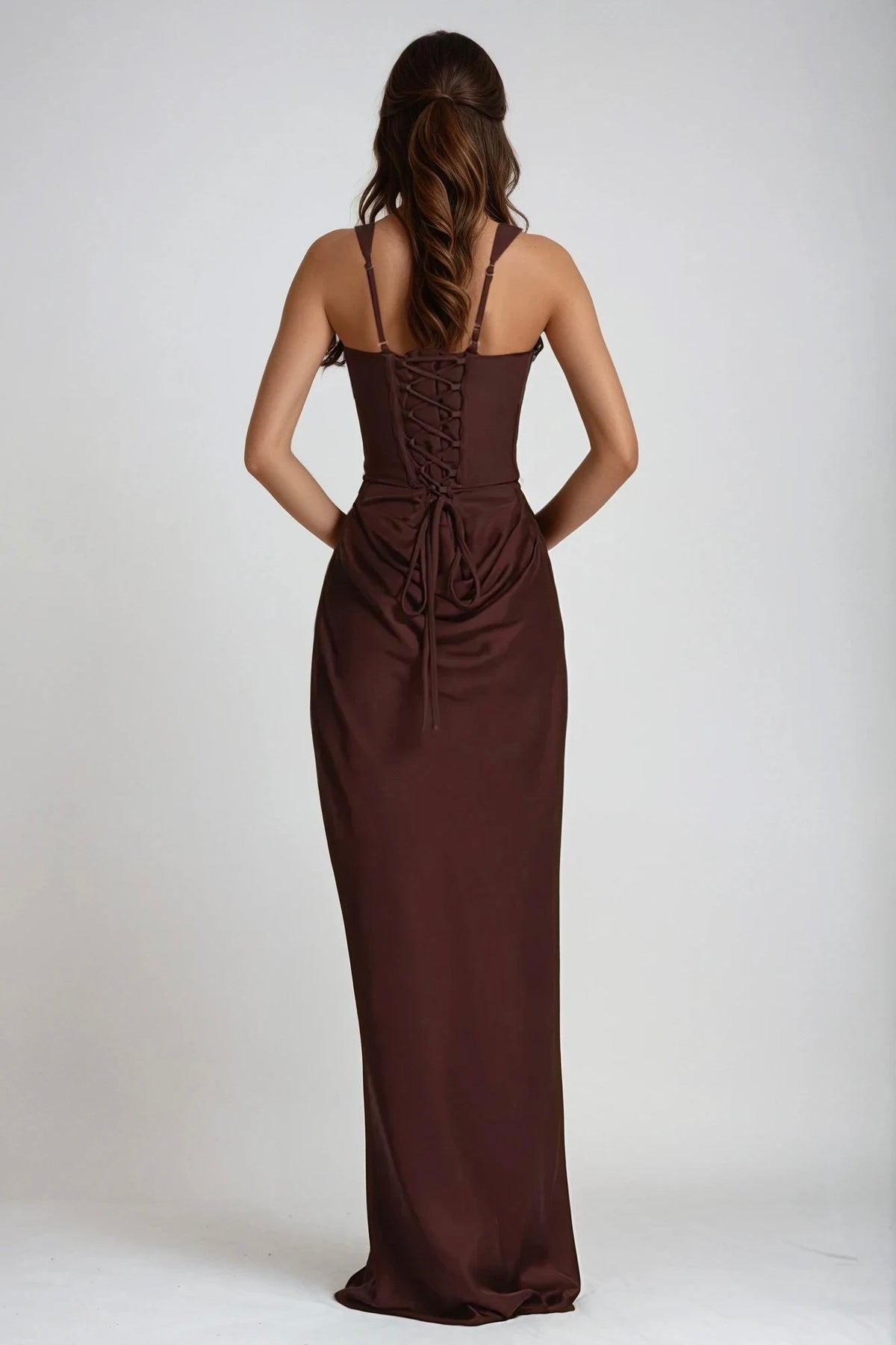 Back of the brown maxi dress, showing the lace-up corset closure with trailing ties and adjustable straps 7