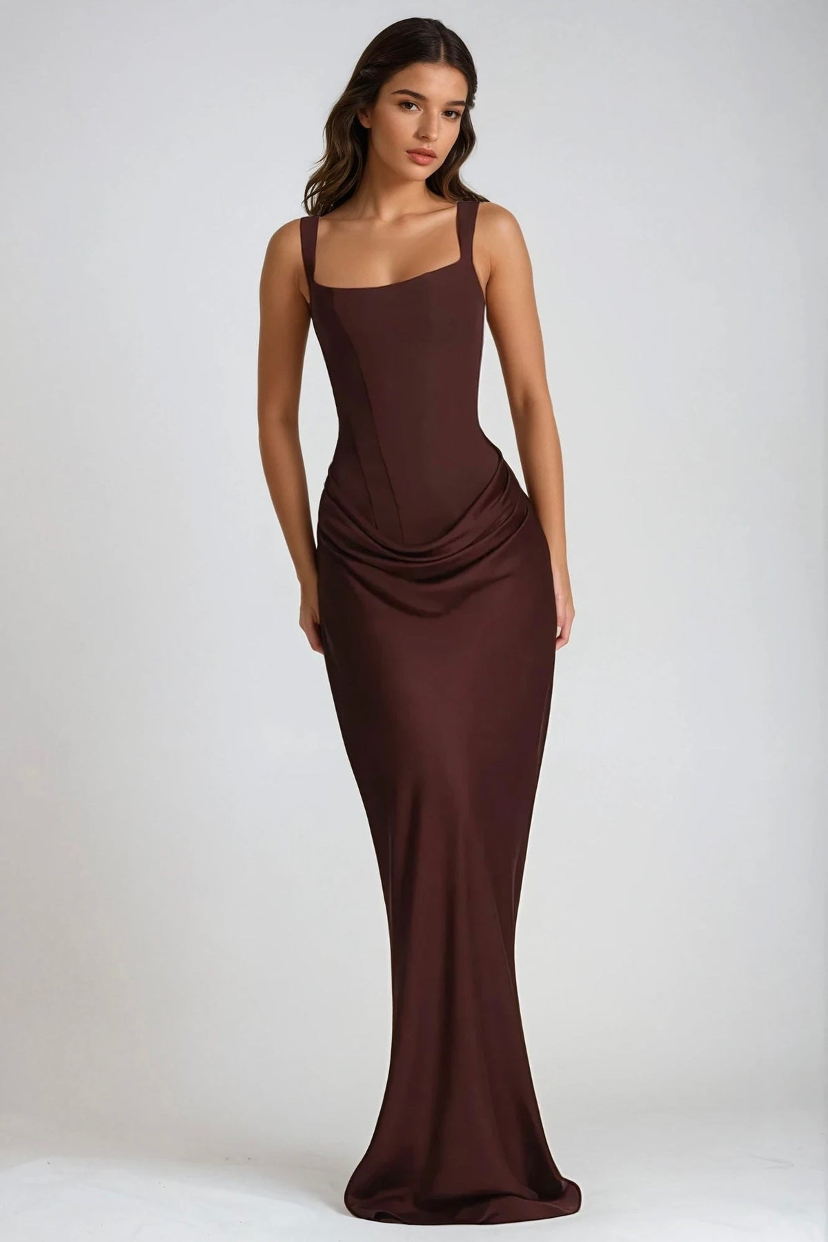 Front view of the dress in dark chocolate brown satin-look fabric, with corset seams and hip drape 5