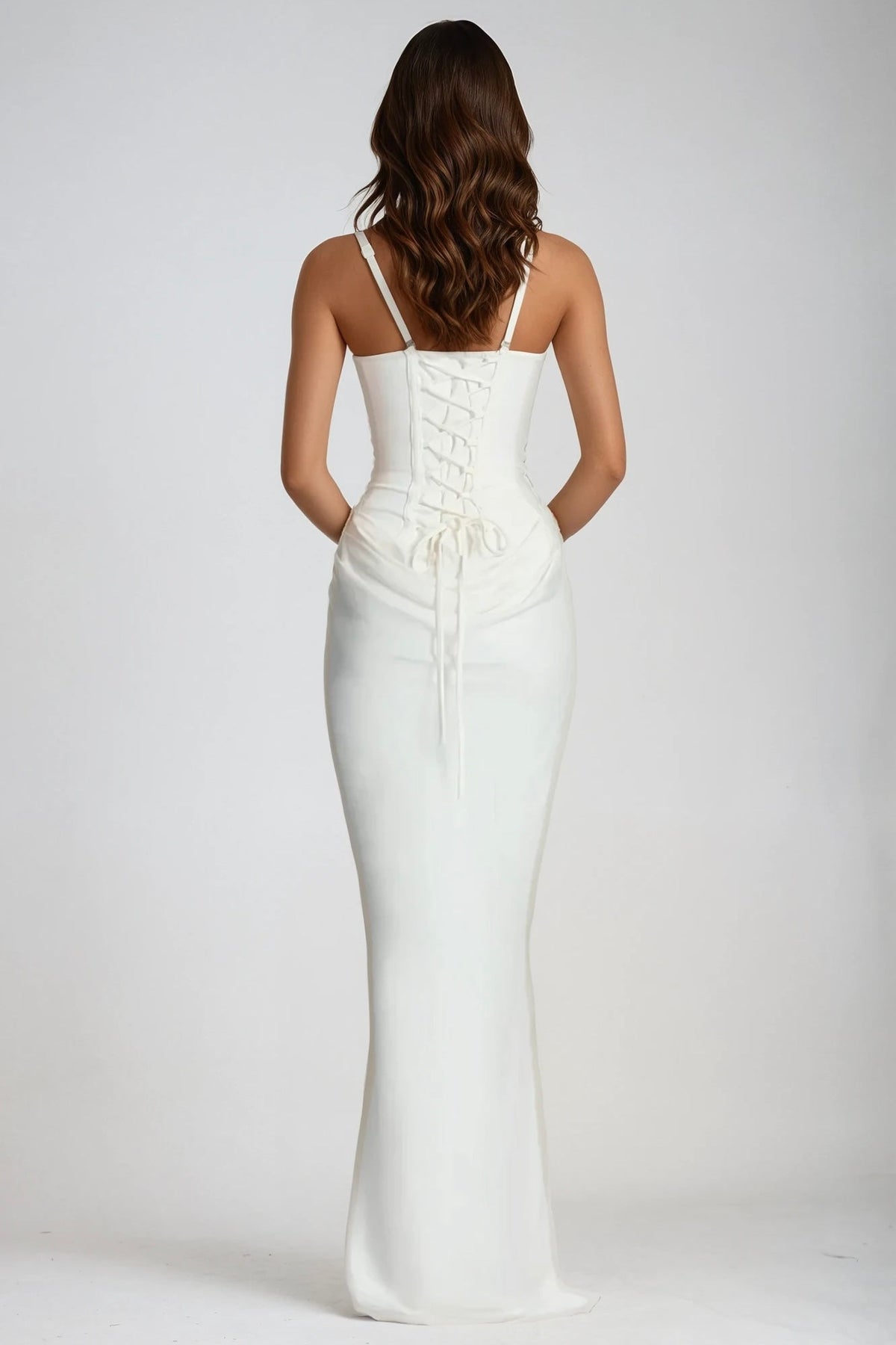 Back view of the white maxi dress, showing the lace-up corset back and thin adjustable straps 3