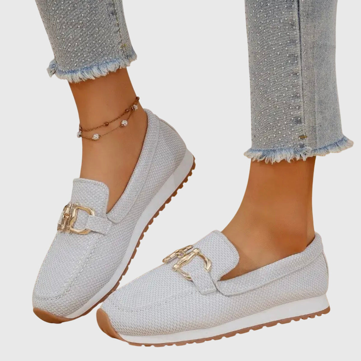 Light grey mesh loafers worn by a model, seen from the side with gold buckle 4