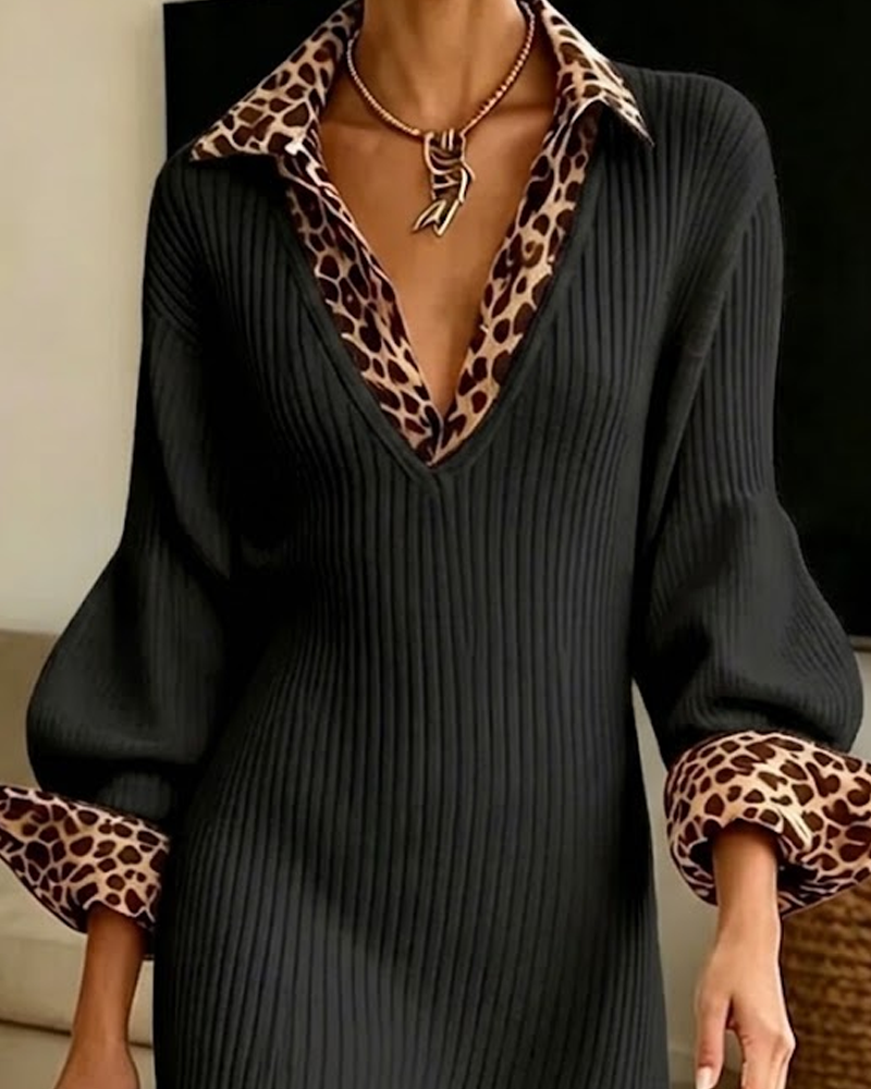 Close-up of the black ribbed knit's V-neckline with leopard collar and cuffs, worn with a gold necklace 6