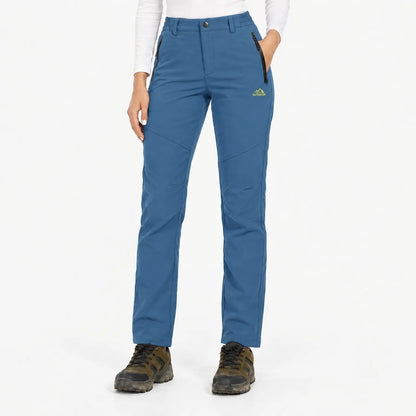 Front view of the trousers in a medium denim blue with zipped front pockets 8